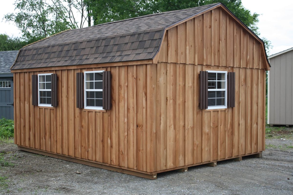 wooden storage shed with shingled roof